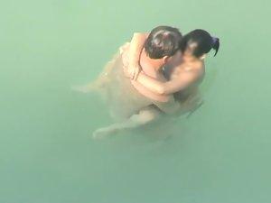 Spying two teenagers fuck in the water Picture 3
