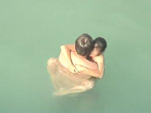 Spying two teenagers fuck in the water Picture 4