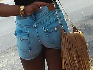 Ghetto girl in booty shorts wait for ride