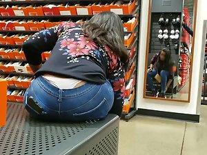 White thong peeks out of jeans when she bends forward