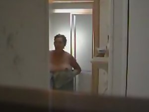 Peeped mother steps out of a shower