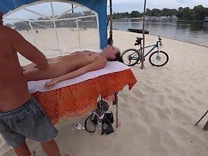 Stunning girl shows off naked body during beach massage Picture 4