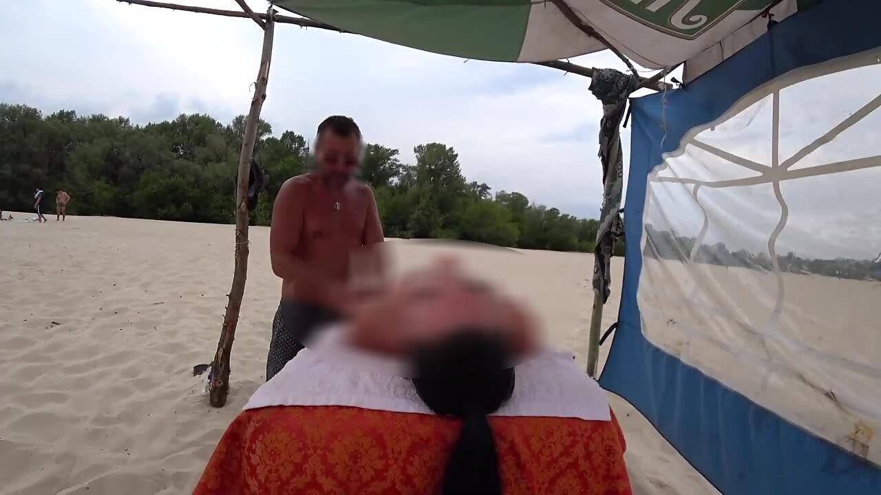 Stunning girl shows off naked body during beach massage