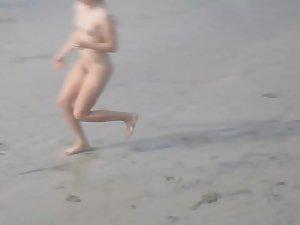 Sporty nudist girl plays frisbee on the beach Picture 3