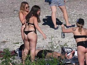 Sexy blonde in polka dot bikini chills with friends on beach Picture 2