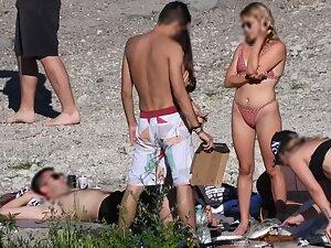 Sexy blonde in polka dot bikini chills with friends on beach Picture 8
