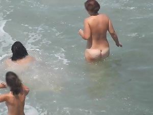 Naked girls having fun in the waves Picture 4