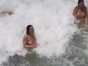 Naked girls having fun in the waves Picture 8