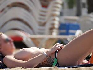 Tattooed girl got big tits in topless on the beach Picture 8