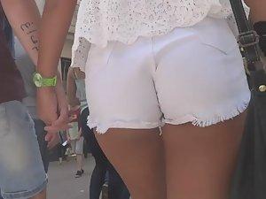 Tanned girl in tight white shorts Picture 2