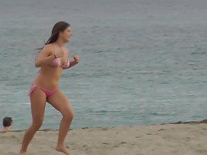 Cute girl chases friends on the beach Picture 1