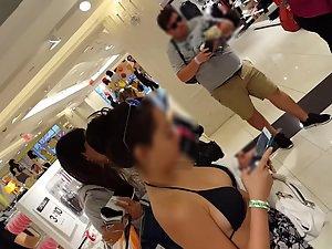 Tattooed girl is wearing a bikini top in shopping mall Picture 2