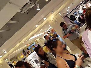 Tattooed girl is wearing a bikini top in shopping mall Picture 3