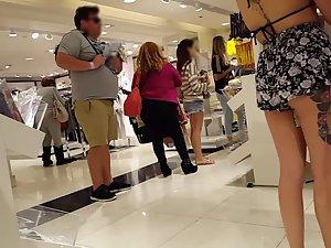 Tattooed girl is wearing a bikini top in shopping mall Picture 4
