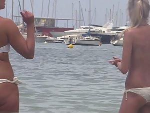 Tiny topless blonde stands in water Picture 5