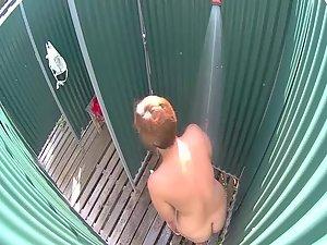 Mature lady caught in a beach shower Picture 4