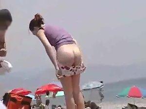 Sexy girl undresses at the beach Picture 2