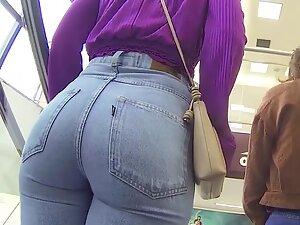 Inspecting how big booty fills up tight blue jeans