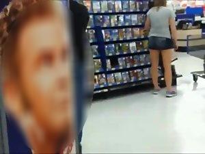 Young chick bends over to pick a movie Picture 2