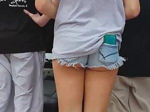 Young ass revealed because of phone in back pocket
