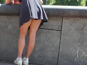 Wind shows upskirt of a busy girl Picture 2