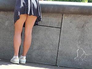 Wind shows upskirt of a busy girl Picture 5