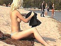 Blonde nudist girl at a beach