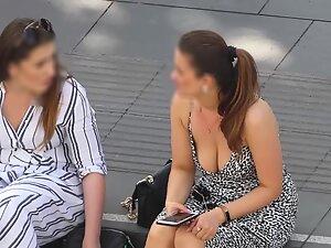 Big boobs of woman sitting and gossiping