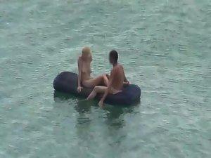 Nude people floating on air mattresses Picture 6