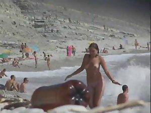 Topless babe gets out of the water Picture 3