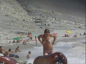 Topless babe gets out of the water Picture 4