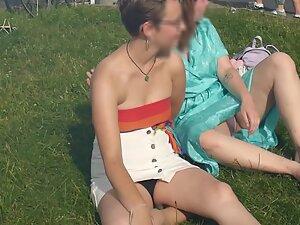 Upskirt of cute lesbian tomboy sitting on the grass