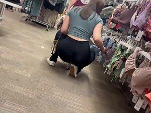 Crouching puts her tight buttocks and thong on display Picture 1