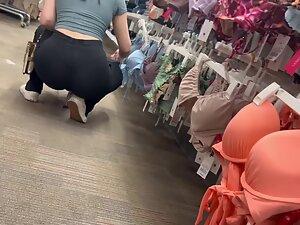 Crouching puts her tight buttocks and thong on display Picture 2