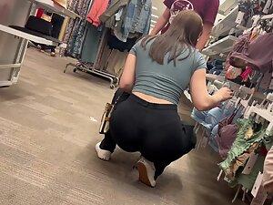 Crouching puts her tight buttocks and thong on display Picture 4