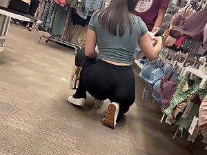 Crouching puts her tight buttocks and thong on display Picture 6