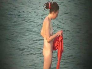 Nude hippie woman getting out of water Picture 7