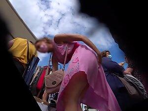 Upskirt under pink dress shows she isn't wearing panties Picture 6