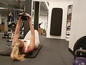 Lazy blonde is on the phone during her workout Picture 1