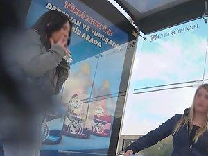 Curvy girl in torn jeans is smoking and waiting for the bus Picture 4