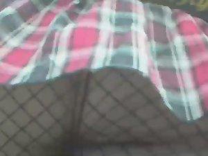 Wind uncovers her fishnet stockings Picture 4