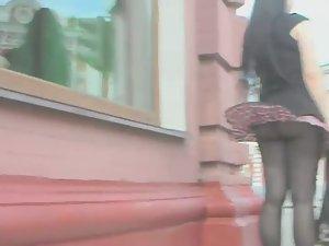 Wind uncovers her fishnet stockings Picture 6