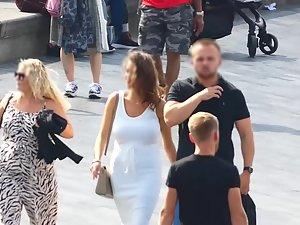 Busty tanned woman in tight white dress Picture 2