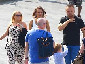 Busty tanned woman in tight white dress Picture 3