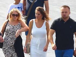 Busty tanned woman in tight white dress Picture 5