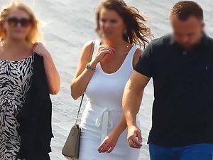 Busty tanned woman in tight white dress Picture 7