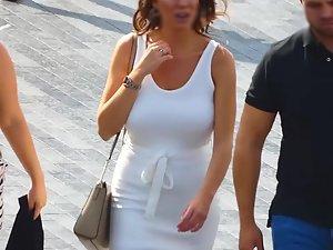 Busty tanned woman in tight white dress Picture 8