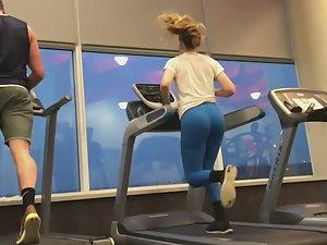 Sexy treadmill runner in blue tights