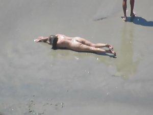Wacky nudist woman rolls in the mud Picture 2