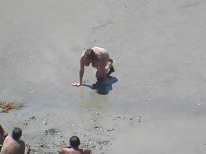 Wacky nudist woman rolls in the mud Picture 4